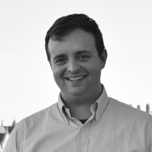 Black-and-white headshot of Aaron Esser-Kahn